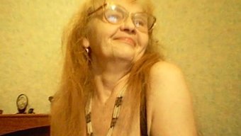 Chris, The Fiery-Haired Mature Woman, Has Her Unique Method Of Pampering Her Visage