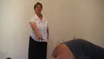 A Mature Woman Punishes A Man With A Cane In Rough Milf Video