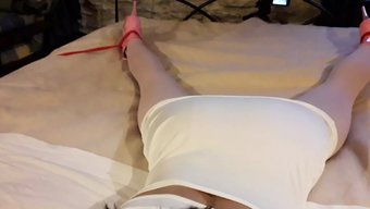 Laura In Seductive White Dress, Pink Tights, And High Heels, Bound And Silenced On A Bed